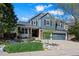 Charming two-story home with a well-maintained lawn, rock features, and an attached two-car garage at 1113 Southbury Pl, Highlands Ranch, CO 80129