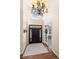 Bright foyer with a soaring ceiling, hardwood floors, coat rack, and transom window above the front door at 1113 Southbury Pl, Highlands Ranch, CO 80129
