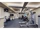 Home gym with sleek black flooring, fitness equipment, and access to other areas at 1113 Southbury Pl, Highlands Ranch, CO 80129