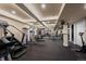Well-lit home gym featuring ample exercise equipment, mirrored walls, and a sleek black floor at 1113 Southbury Pl, Highlands Ranch, CO 80129