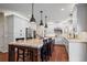 Open kitchen with a large island featuring granite countertops, white cabinetry, and stainless steel appliances at 1113 Southbury Pl, Highlands Ranch, CO 80129