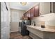 Functional laundry room with modern appliances, storage cabinets, and a sink at 1113 Southbury Pl, Highlands Ranch, CO 80129