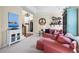 Cozy living room featuring a tray ceiling, comfortable seating, and views into the entryway at 1113 Southbury Pl, Highlands Ranch, CO 80129