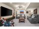 Basement living area with a large TV, comfortable seating, and stylish decor, ideal for entertainment at 1113 Southbury Pl, Highlands Ranch, CO 80129