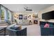 Cozy living room with a fireplace, comfortable seating, and stylish decor at 1113 Southbury Pl, Highlands Ranch, CO 80129