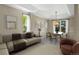 Open-concept living and dining area with neutral decor, large windows, and elegant lighting fixture at 1113 Southbury Pl, Highlands Ranch, CO 80129