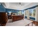 Spacious primary bedroom with hardwood floors, tray ceiling, and large windows offering plenty of natural light at 1113 Southbury Pl, Highlands Ranch, CO 80129