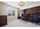 Home office featuring custom built-in shelving, ample desk space, and natural light at 1113 Southbury Pl, Highlands Ranch, CO 80129