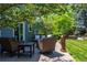 Relaxing patio area with comfortable seating, mature trees and lush landscaping provide a serene outdoor retreat at 1113 Southbury Pl, Highlands Ranch, CO 80129