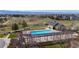 Outdoor pool area with a pool house, pergola, manicured landscaping, and a park backdrop at 1113 Southbury Pl, Highlands Ranch, CO 80129