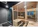 Home sauna room featuring built-in wood benches, glass doors, and a tiled shower at 1113 Southbury Pl, Highlands Ranch, CO 80129