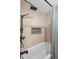 Shower with bronze fixtures and a decorative shower cubby tiled with green, leafy accents at 1113 Southbury Pl, Highlands Ranch, CO 80129