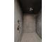 Contemporary shower showcasing gray tile walls, matte black hardware, and recessed lighting at 1113 Southbury Pl, Highlands Ranch, CO 80129