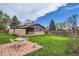 Green backyard featuring patio, seating area and mature trees at 7245 W 70Th Ave, Arvada, CO 80003