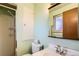 Functional bathroom featuring a shower, toilet, vanity with mirror and fresh, light-green paint at 7245 W 70Th Ave, Arvada, CO 80003