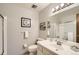 Simple bathroom with a shower and modern vanity featuring a large mirror and white walls at 7245 W 70Th Ave, Arvada, CO 80003