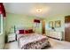 Bright bedroom featuring a floral bedspread, two windows and a dresser with coordinated decor at 7245 W 70Th Ave, Arvada, CO 80003