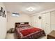Cozy bedroom with double closets, window and wood-trimmed headboard and bedside table at 7245 W 70Th Ave, Arvada, CO 80003