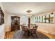 Dining room featuring hardwood floors, classic china cabinet, and rustic wooden table set at 7245 W 70Th Ave, Arvada, CO 80003