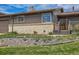 Close up exterior shot of cozy home with brick accents, a well-manicured lawn, and inviting front entrance at 7245 W 70Th Ave, Arvada, CO 80003