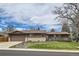 Charming single-story home featuring a cozy front porch, well-maintained lawn, and a two-car garage at 7245 W 70Th Ave, Arvada, CO 80003