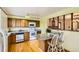Bright and functional kitchen showcasing wooden cabinetry, white appliances, and an open layout at 7245 W 70Th Ave, Arvada, CO 80003