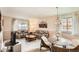 Bright living room featuring comfortable seating, neutral walls, and plenty of natural light from large windows at 7245 W 70Th Ave, Arvada, CO 80003