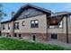 Home with brick exterior, well-maintained lawn, and gravel area in the backyard at 1399 Newton St, Denver, CO 80204
