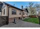 Spacious backyard with a well-maintained lawn, gravel area and brick exterior at 1399 Newton St, Denver, CO 80204