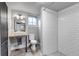 Modern bathroom featuring a white sink, tiled shower and a bright window at 1399 Newton St, Denver, CO 80204