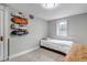 Cozy bedroom featuring skateboards mounted on the wall and a sunlit window at 1399 Newton St, Denver, CO 80204
