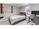 Bedroom boasts a wooden headboard, a computer desk, and mounted fishing poles at 1399 Newton St, Denver, CO 80204