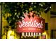 Charming Seedstock Brewery sign is lit at night with a red and white logo and retro design at 1399 Newton St, Denver, CO 80204