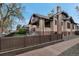 Brick home with a fenced yard, offering privacy and a well-maintained lawn at 1399 Newton St, Denver, CO 80204
