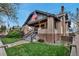 Charming brick home featuring a cozy front porch and well-maintained lawn at 1399 Newton St, Denver, CO 80204