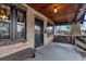 Inviting front porch with wood ceiling, bench, swing and shaded seating area at 1399 Newton St, Denver, CO 80204