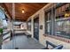 Cozy front porch with wood ceiling, bench seating, and swing for relaxation at 1399 Newton St, Denver, CO 80204