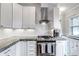 Stylish kitchen featuring subway tile backsplash, stainless steel appliances, and white cabinetry at 1399 Newton St, Denver, CO 80204