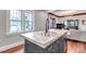 Open kitchen view to the living room, featuring modern island with concrete countertop at 1399 Newton St, Denver, CO 80204