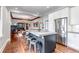 Bright open kitchen featuring a large island, stainless steel appliances, and hardwood floors at 1399 Newton St, Denver, CO 80204
