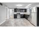 Open kitchen boasts stainless appliances, wood counters, and ample space at 1399 Newton St, Denver, CO 80204