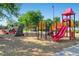 Colorful community playground with climbing structures, slides, and swings on a safe, wood-chip ground surface at 1399 Newton St, Denver, CO 80204