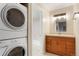 Bathroom featuring modern washer and dryer next to vanity at 7665 E Eastman Ave # 302B, Denver, CO 80231