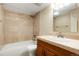 Bathroom featuring a tub shower with tile surround, vanity and a mirrored medicine cabinet at 7665 E Eastman Ave # 302B, Denver, CO 80231