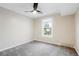 Neutral bedroom with new carpet, a ceiling fan, and a bright window view at 7665 E Eastman Ave # 302B, Denver, CO 80231