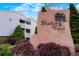 Stone community sign for Shadow Wood surrounded by colorful bushes and a view of the apartments at 7665 E Eastman Ave # 302B, Denver, CO 80231