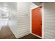 Entrance to unit number 302 with a bright orange door at 7665 E Eastman Ave # 302B, Denver, CO 80231