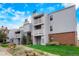 Exterior view of a two-story apartment building featuring brick accents and individual balconies at 7665 E Eastman Ave # 302B, Denver, CO 80231