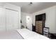 Bedroom with closet, chest of drawers with television, and an open doorway leading to the stairs at 1885 S Quebec Way # G 106, Denver, CO 80231
