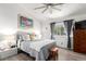 Bedroom with a ceiling fan and a view of a tree outside the window at 1885 S Quebec Way # G 106, Denver, CO 80231